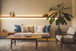A cozy living room with a beige sofa, blue cushions, and warm lighting